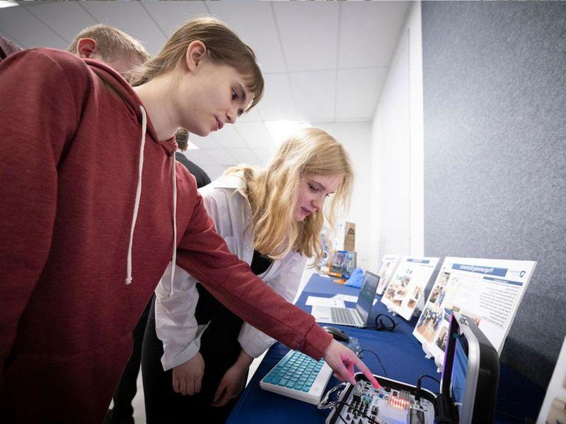 Two people looking at a computer